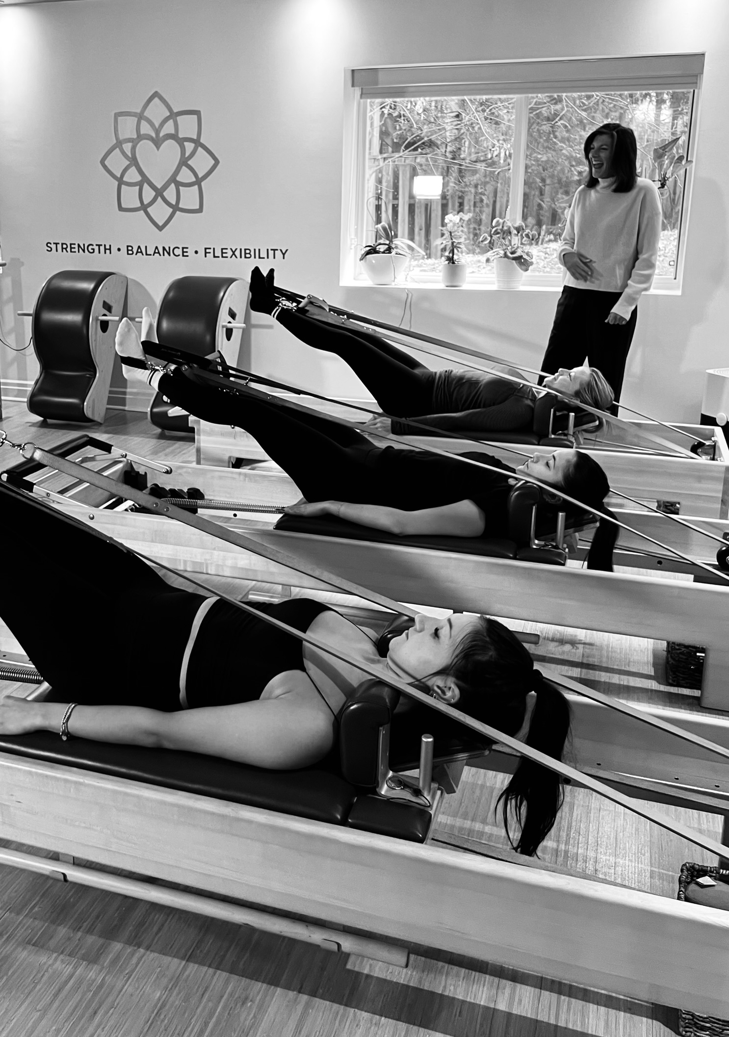 Kim guiding a client on the Pilates Reformer at Heart of Movement, Oakville's classical Pilates studio in Kerr Village