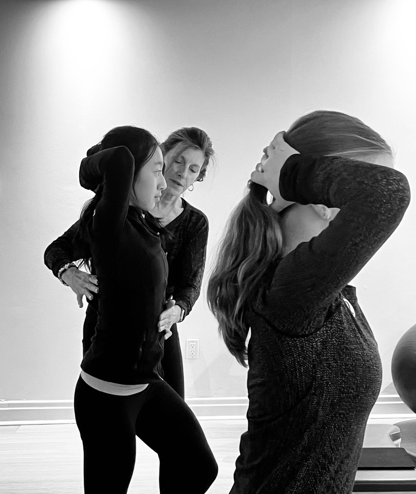 Kim guiding a client in a private Pilates session